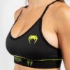 Women's sports bra Venum black with a yellow logo on the front